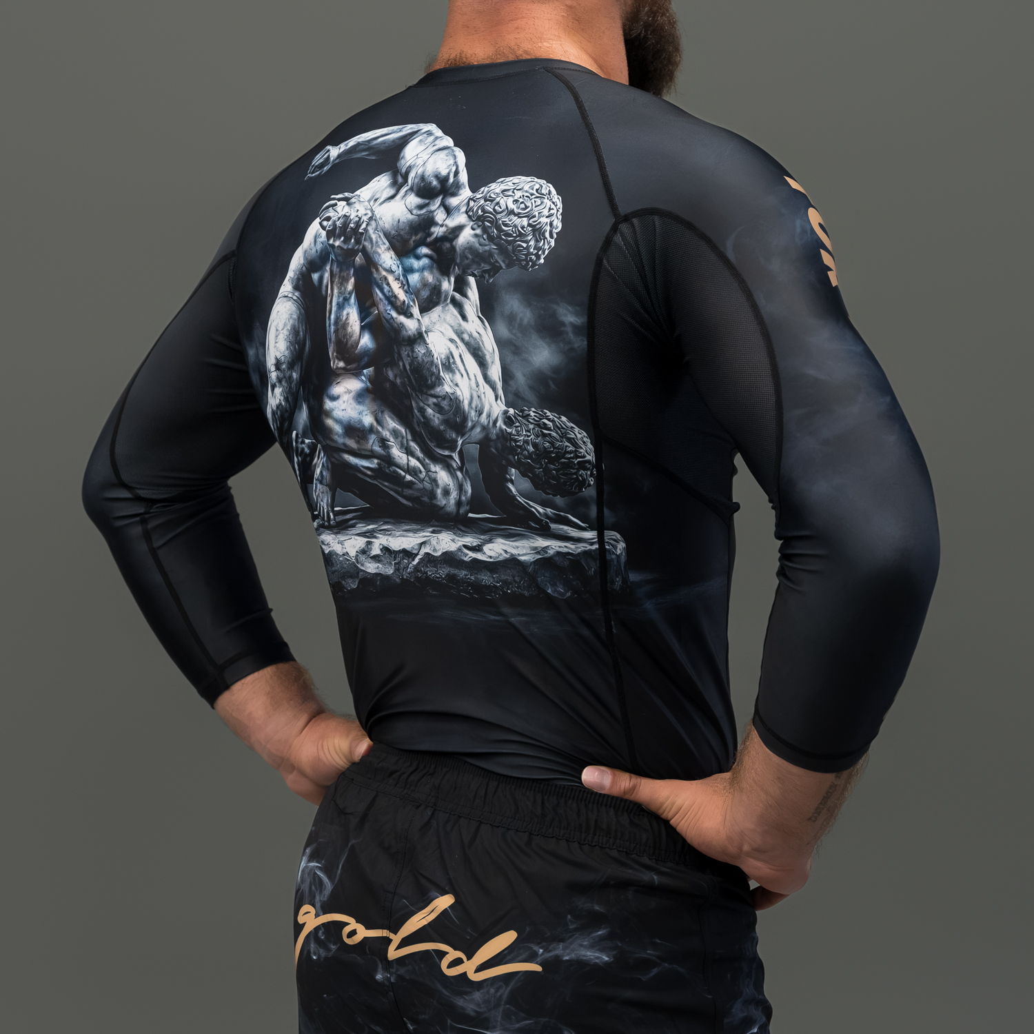 Man in black athletic shirt with detailed graphic on back.