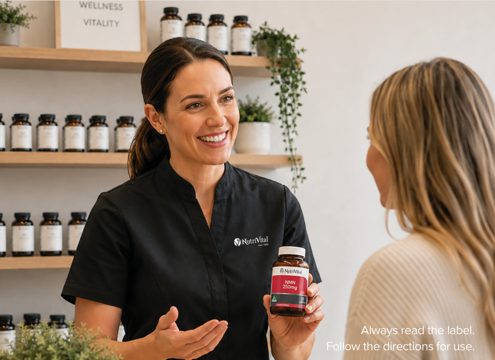 Person in a black shirt discussing supplements with another person in a store.