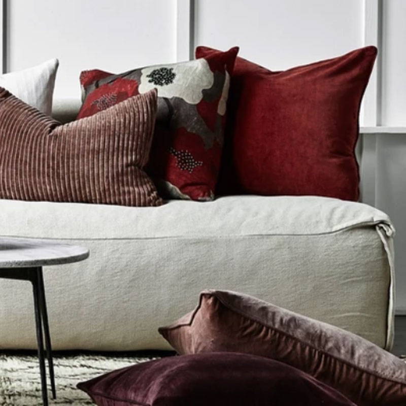 Red velvet cushions in contemporary living room
