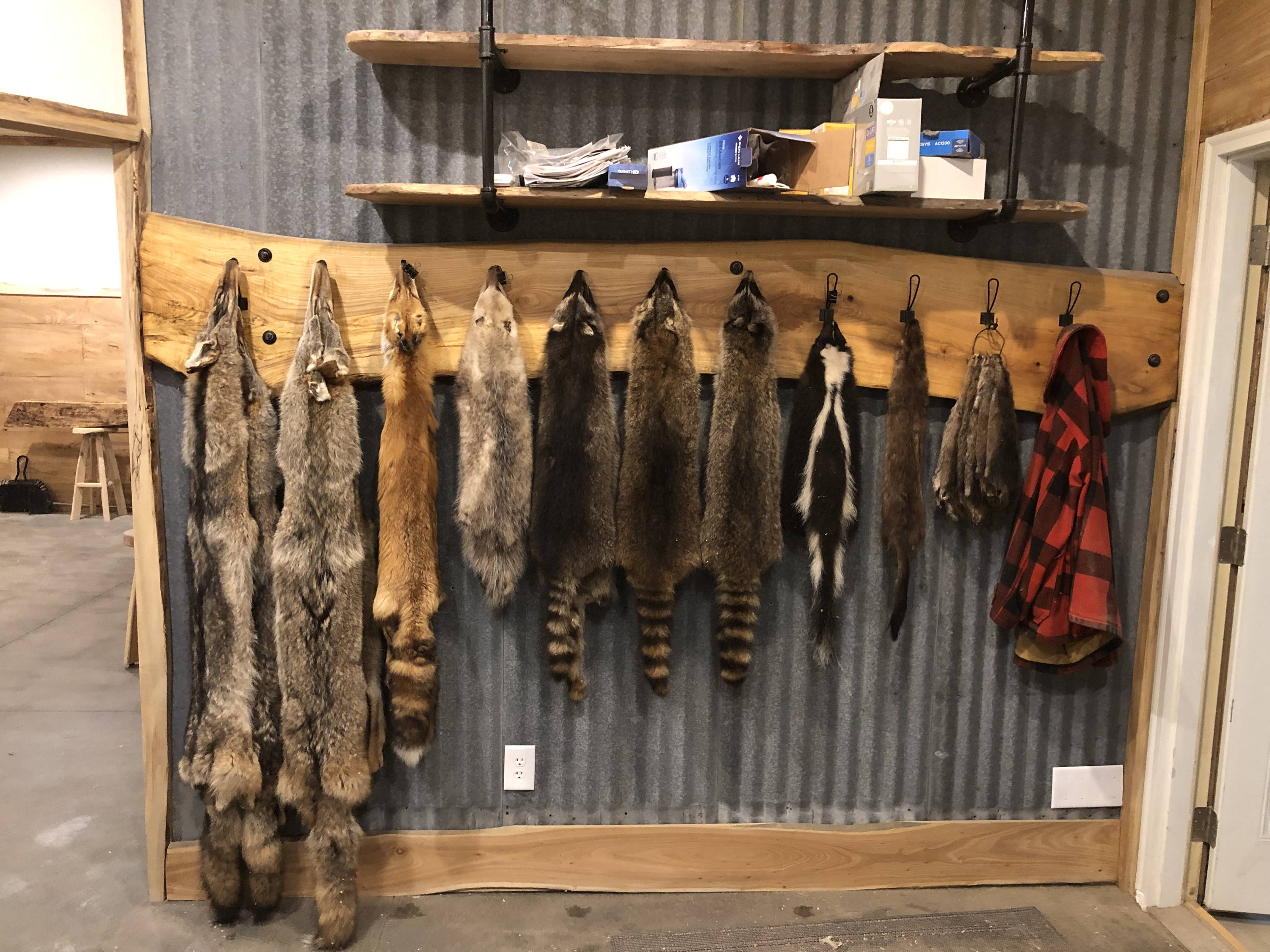 coat rack with animal furs and coats hanging
