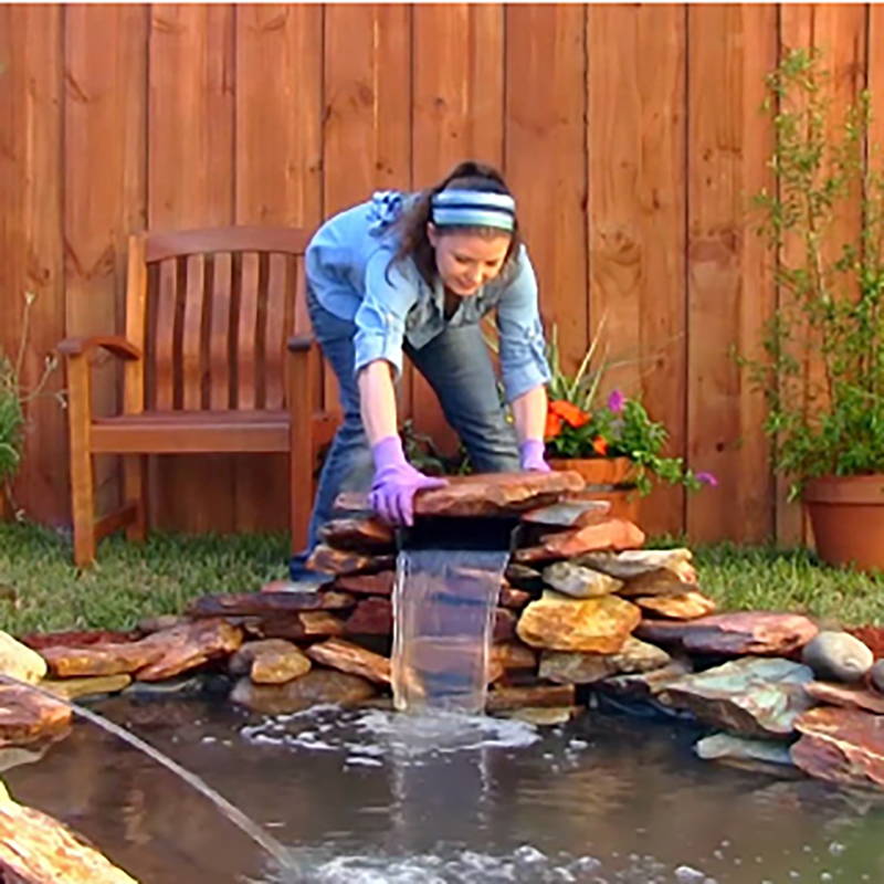 use landscaping stone to disguise the diy waterfall