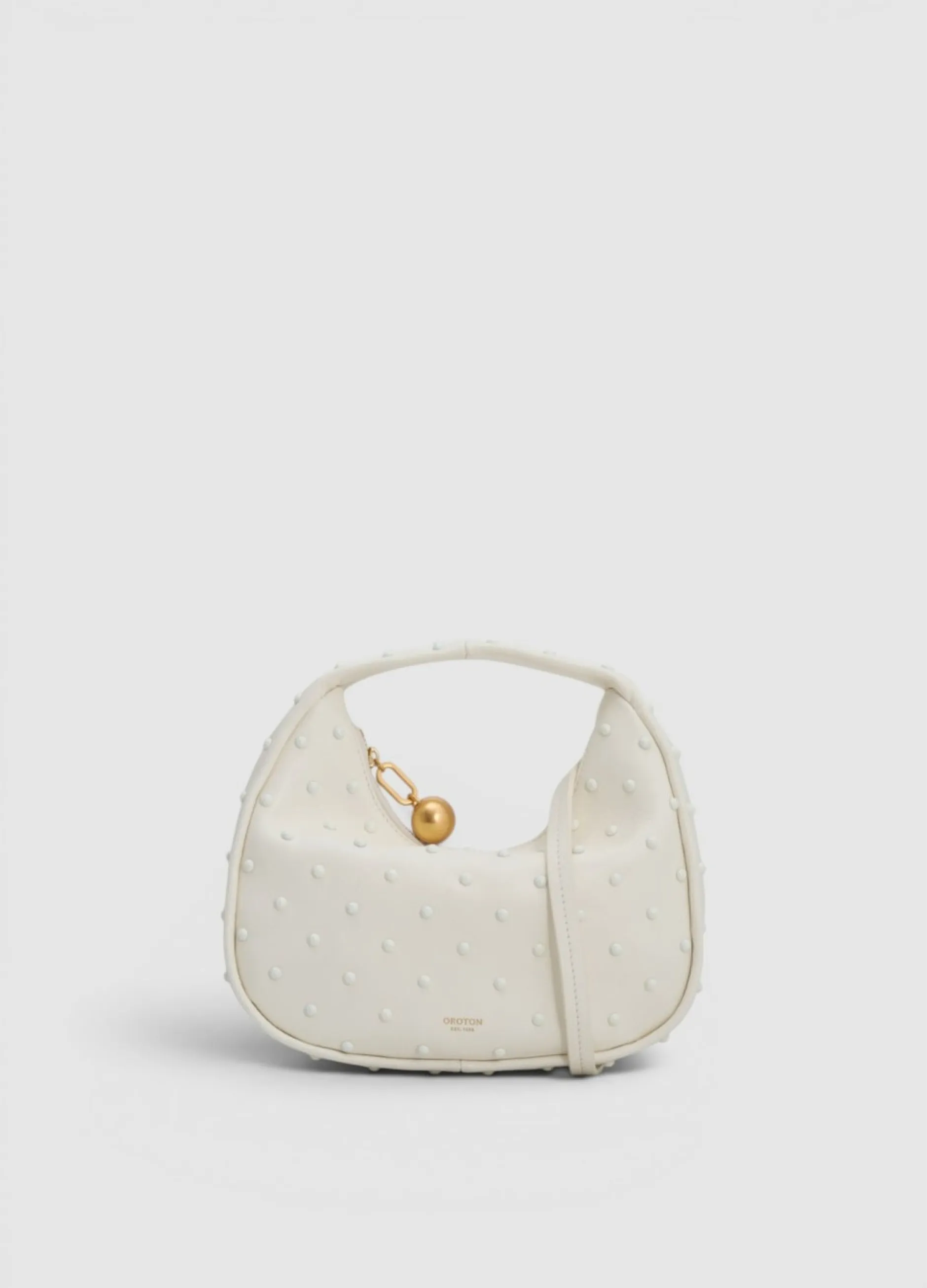 White handbag with a textured surface and a gold accent.