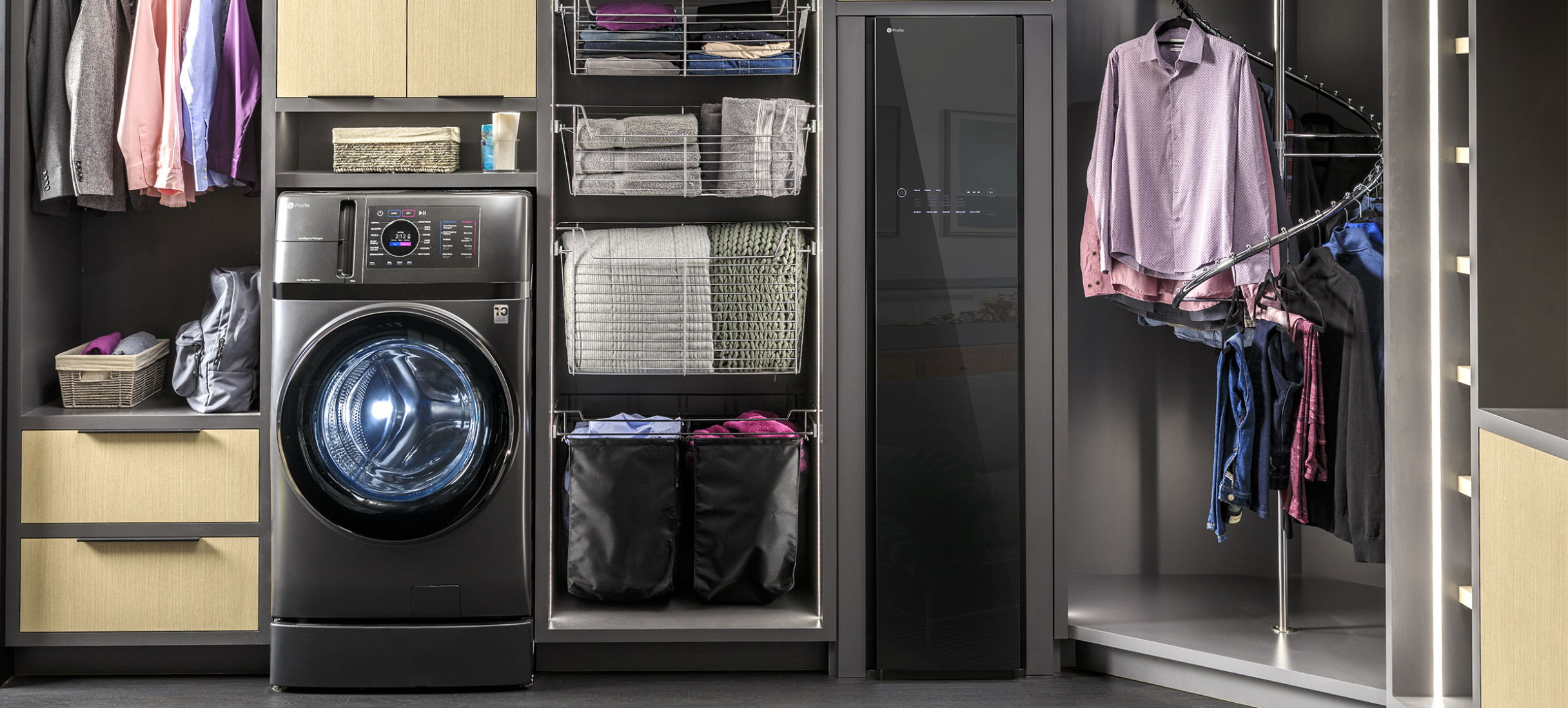 A modern laundry setup with washer, dryer, and organized clothing storage.