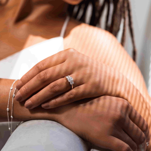 woman wearing a lab grown diamond bracelet and an engagement ring set with a lab grown diamond by MiaDonna