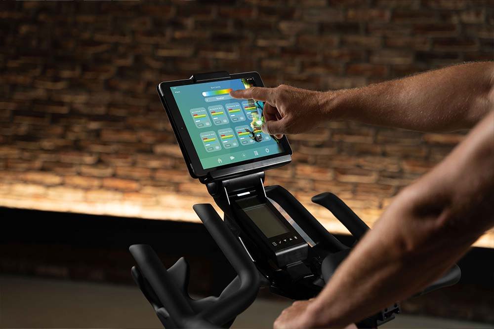 Touching tablet on device holder on ICG exercise bike