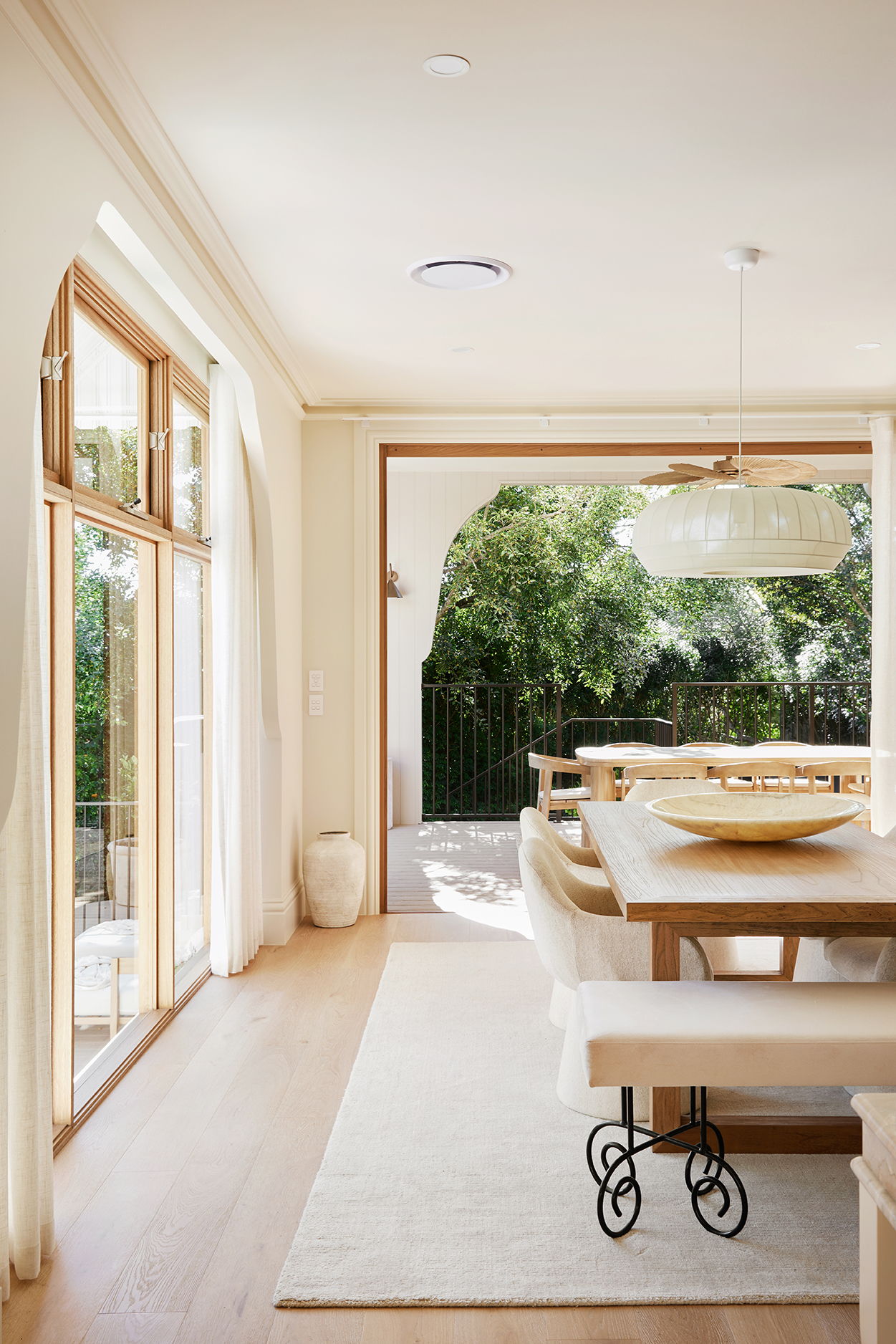 Bright, modern dining area with a large table and outdoor view.