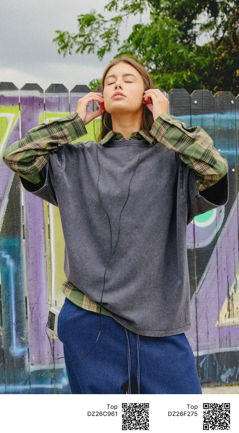 Person wearing headphones, eyes closed, against a graffiti background.