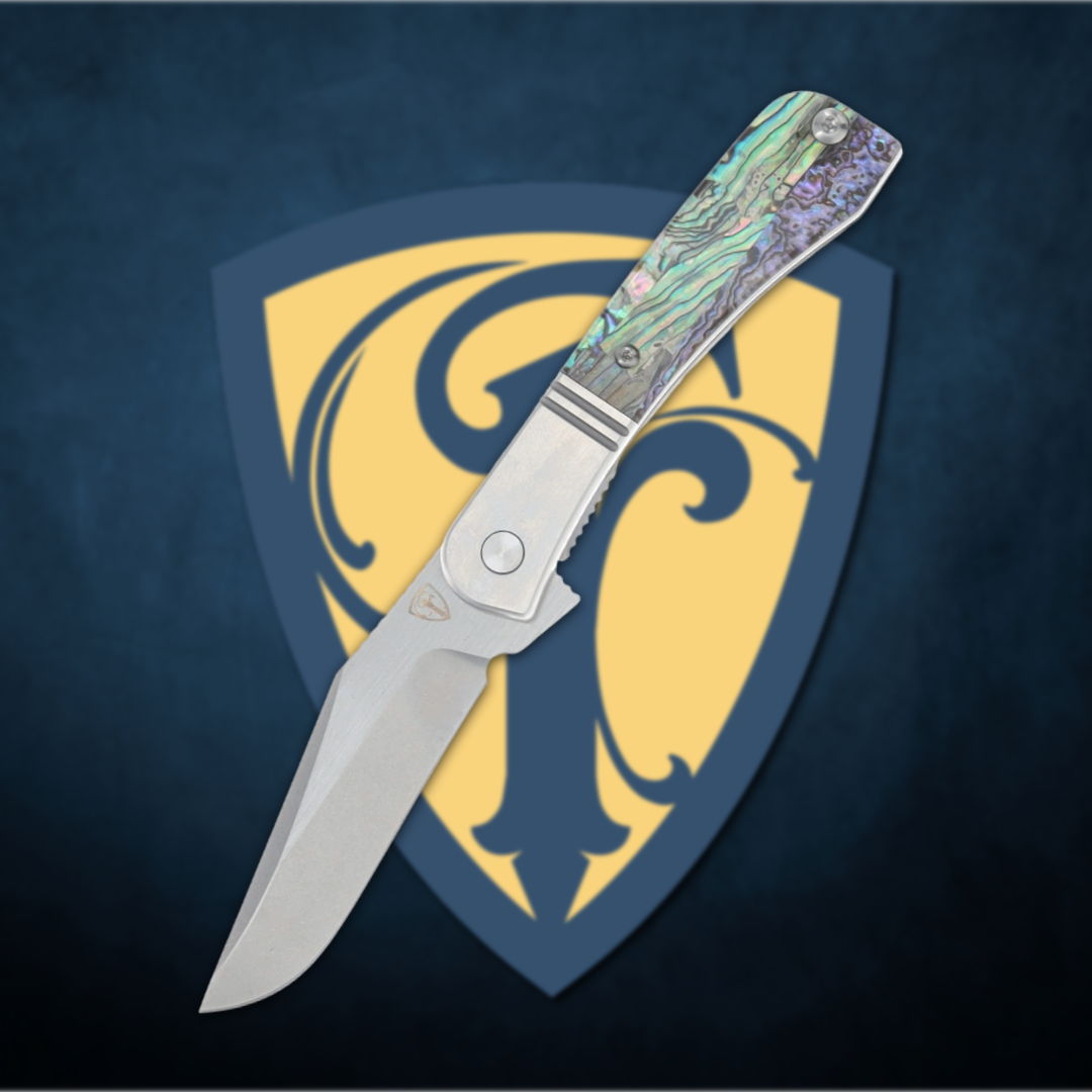 A folding knife with a decorative handle on a shield background.