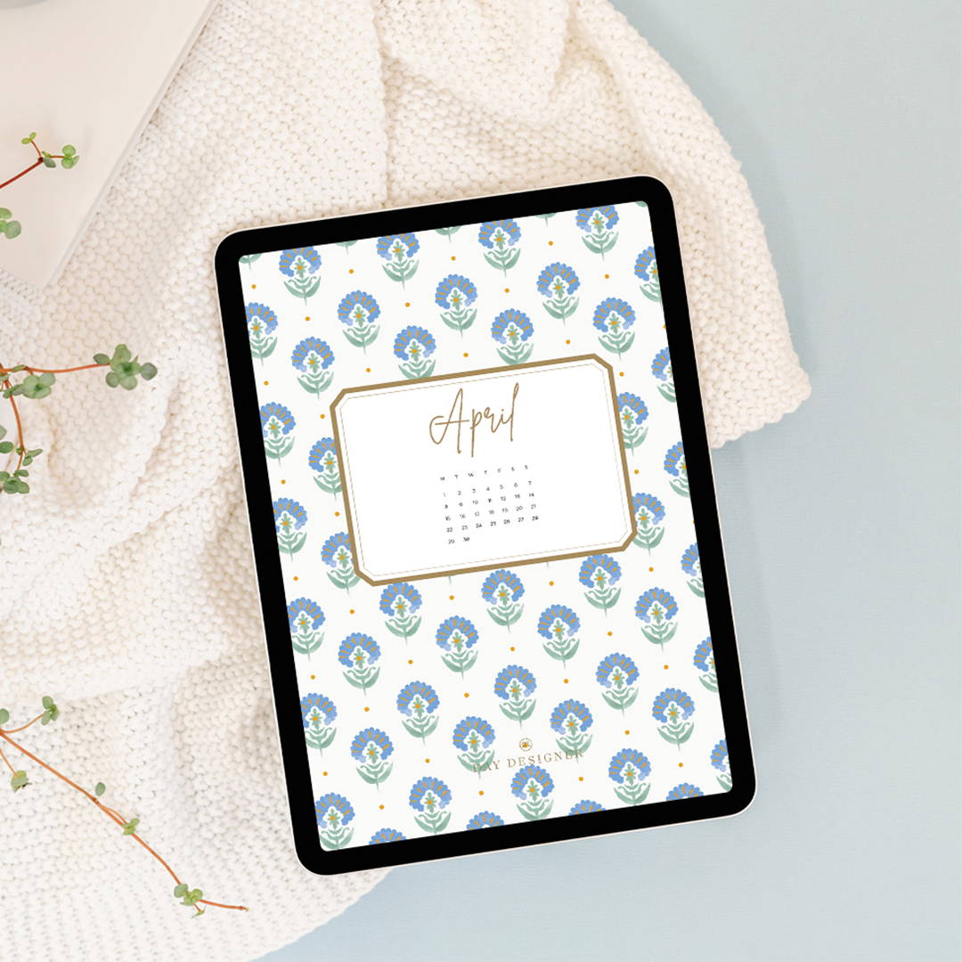 april 2024 digital wallpaper in repeated green and blue floral design on a tablet, cream blanket, branches on sage green background