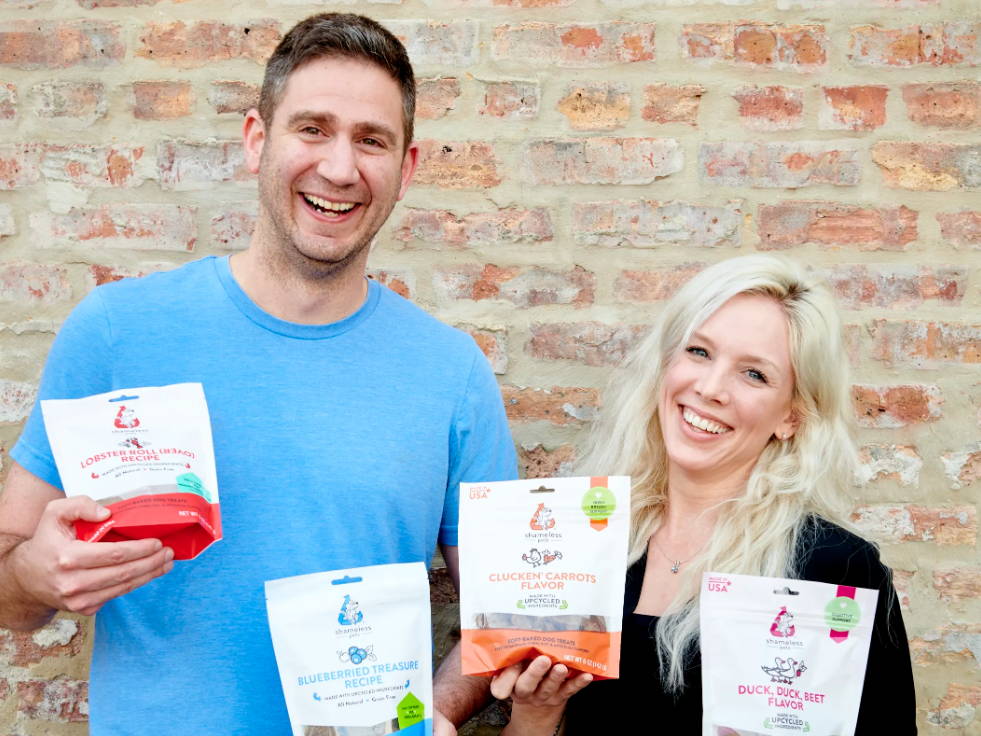 Shameless Pets founders, James Bellow and Alex Waite holding upcycled cat and dog treats