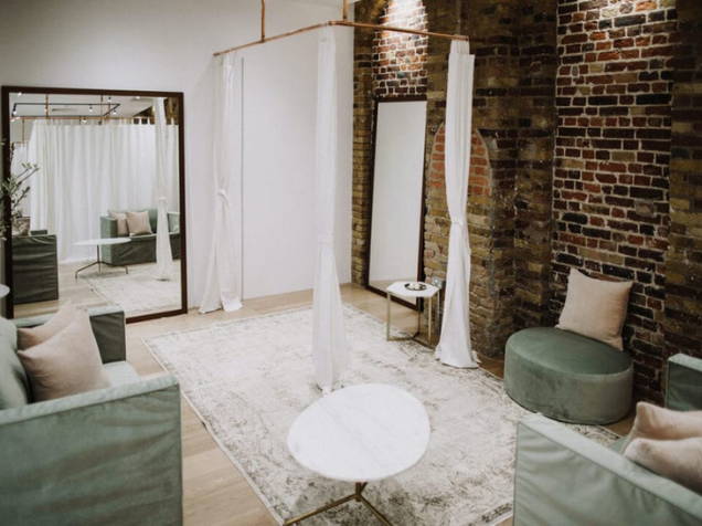 The exposed brick and copper detailing changeroom in the Grace Loves Lace Shoreditch bridal shop
