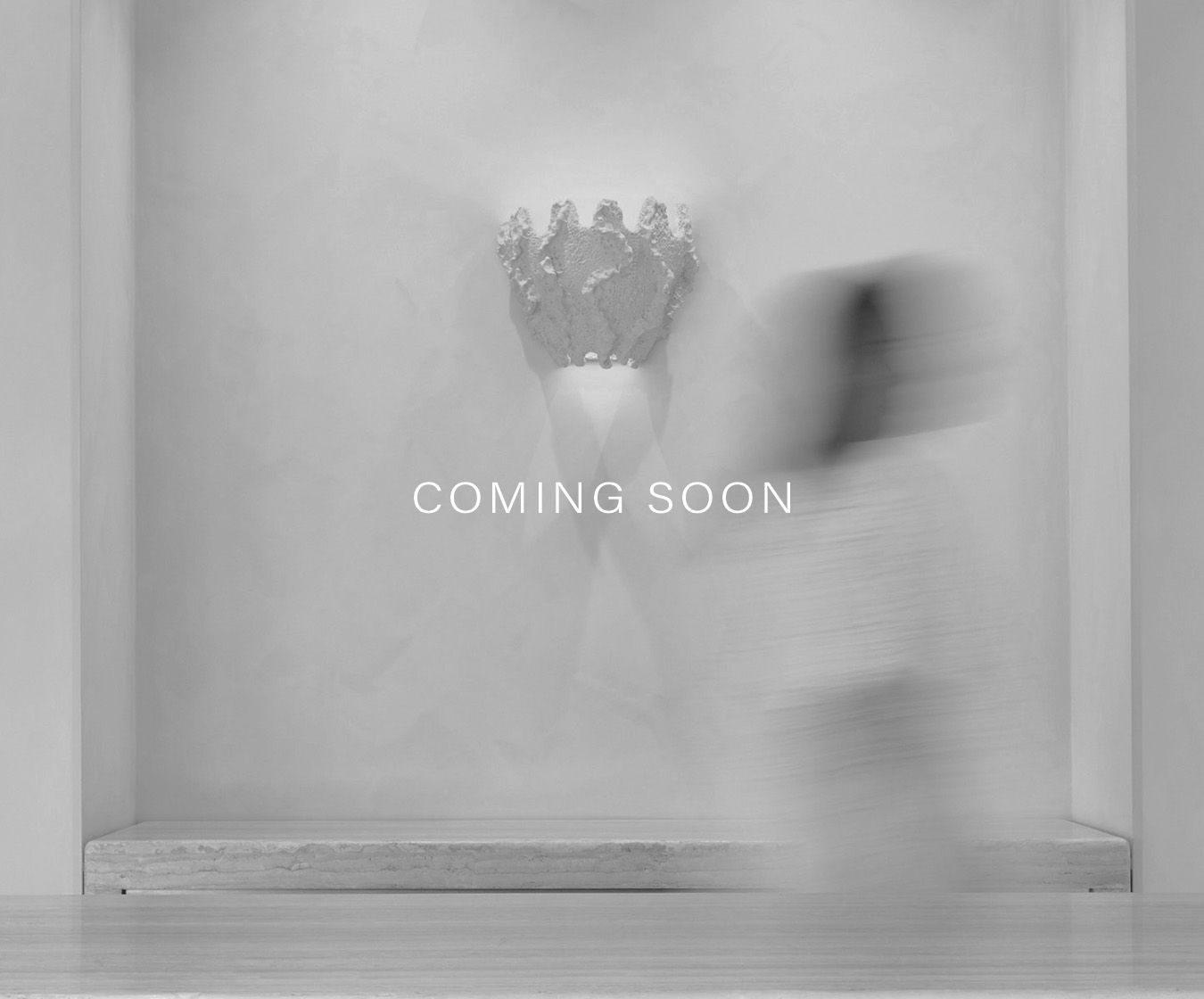 COMING SOON - Black and white imagery of wall in store with shell light