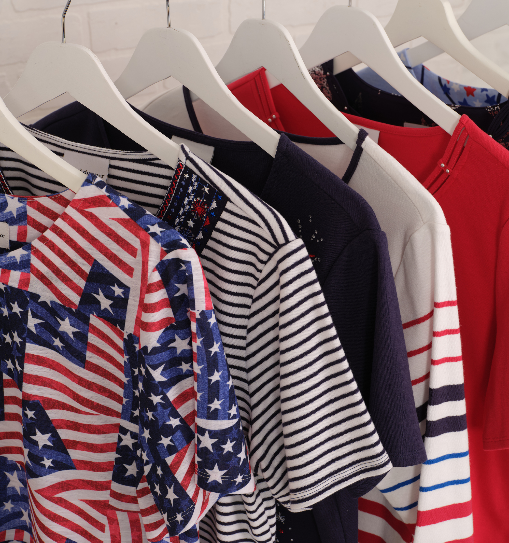 A collection of shirts with various patterns, including stripes and stars.