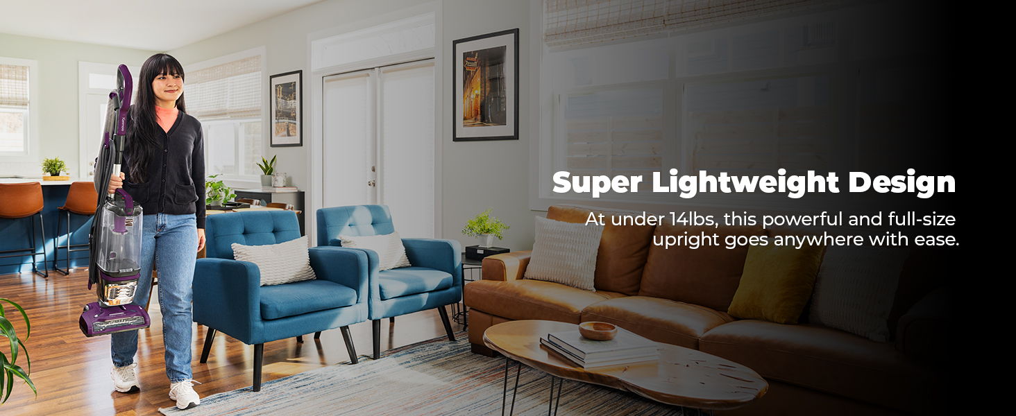 A person carrying a vacuum cleaner in a modern living room setting.