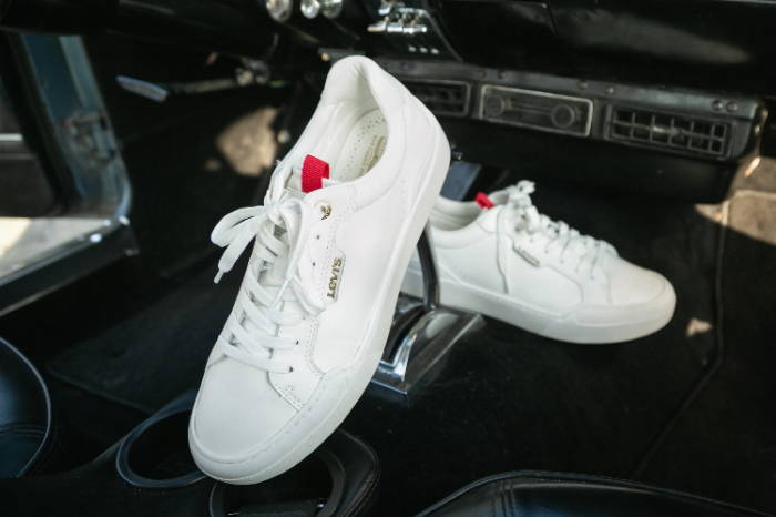 Levi's 521  XX  EST LO Leather sneakers resting on the center console of car 