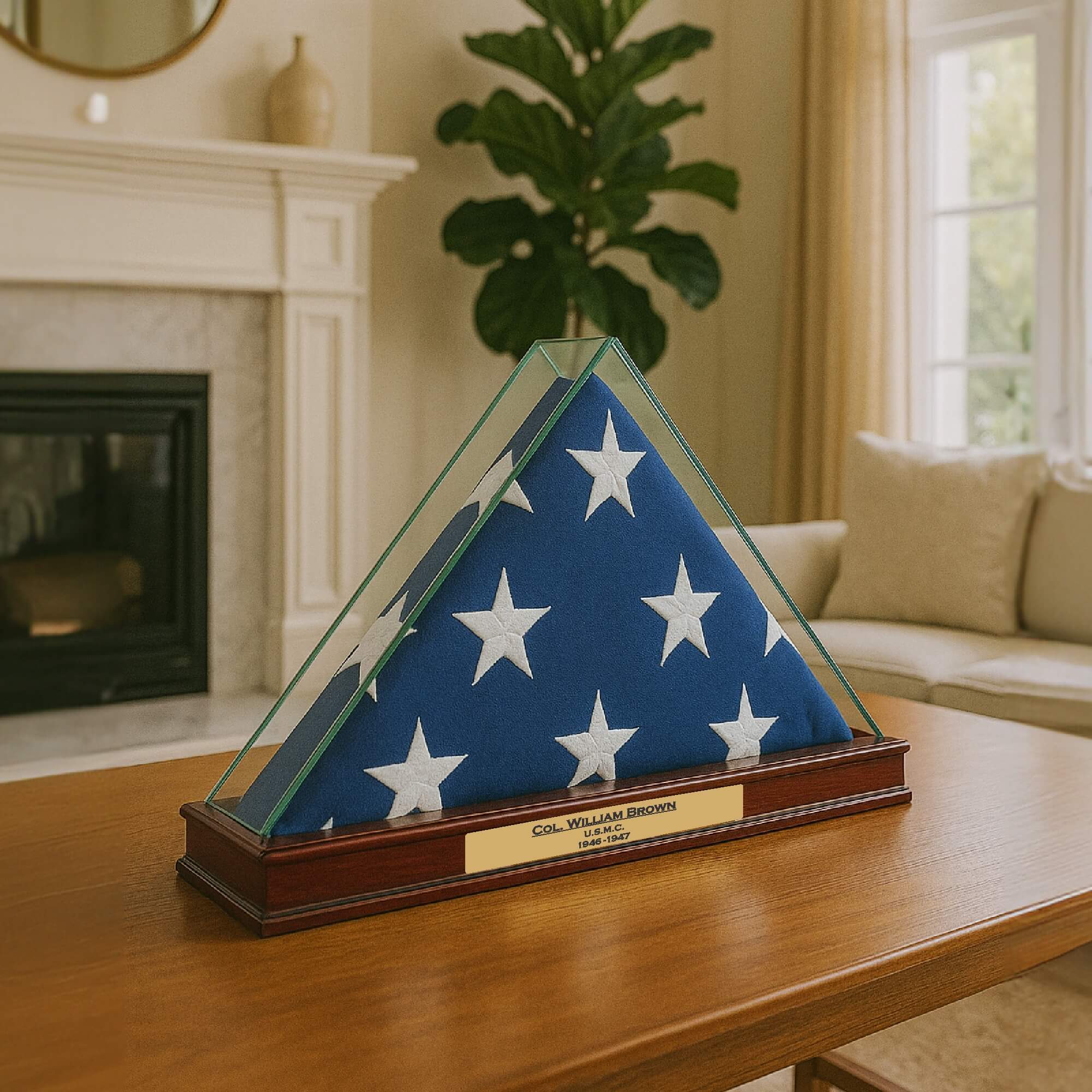 A folded American flag displayed in a triangular glass case on a table.