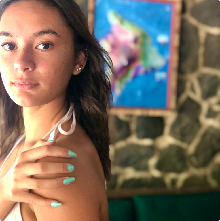young women touching her arm wearing toxin free nail polish in kapoho dreams