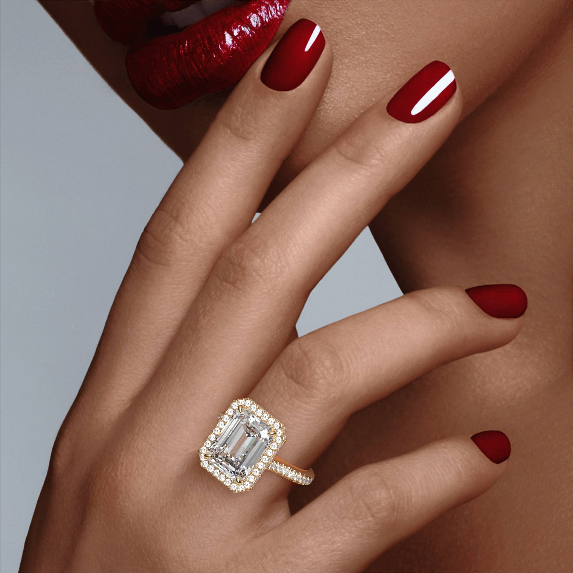 emerald cut halo engagement ring on hand