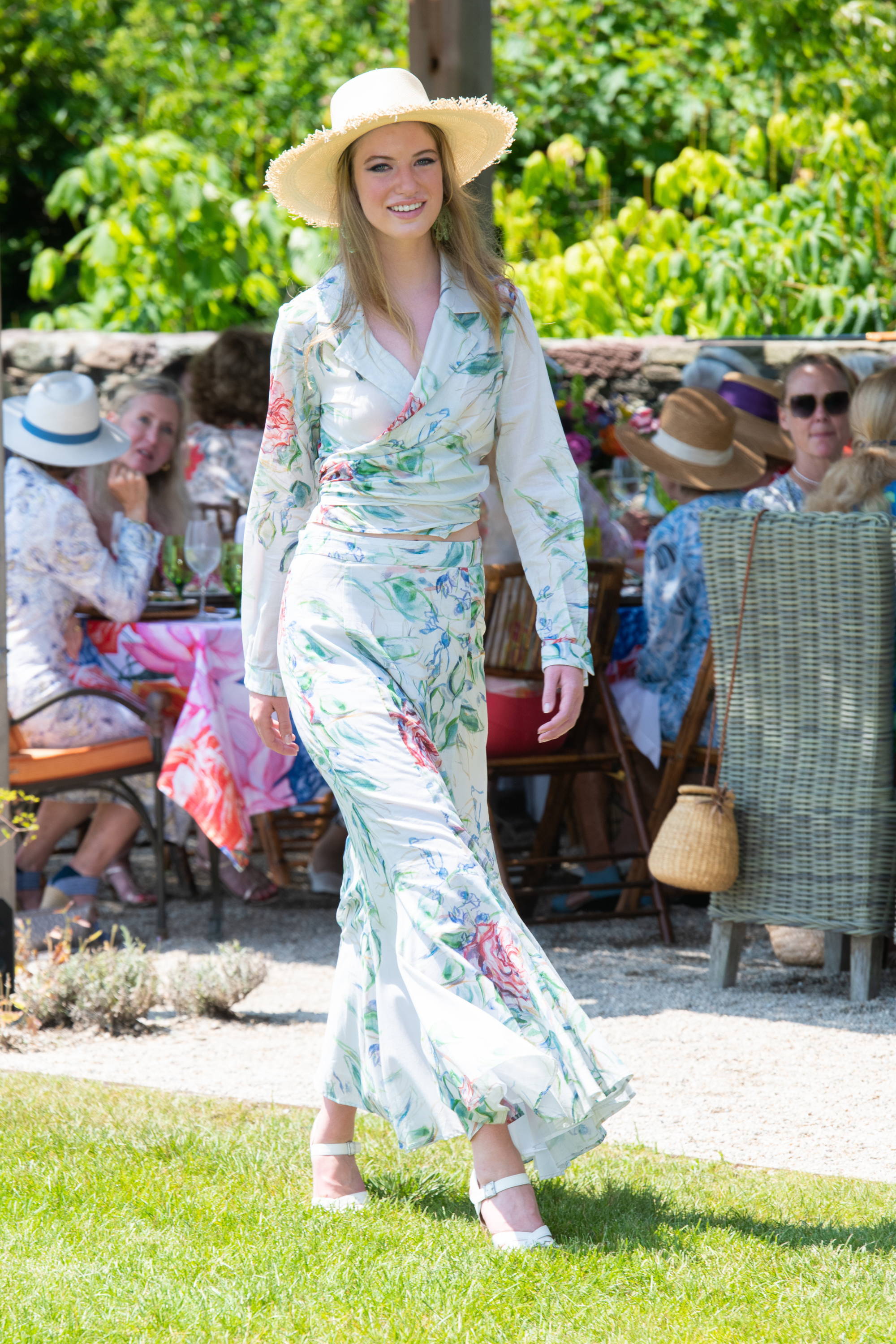 Model wearing rose printed wrap top with matchng skirt at the Ala von Auersperg Newport Fashion Show hosted by Ala Isham in Newport Rhode Island