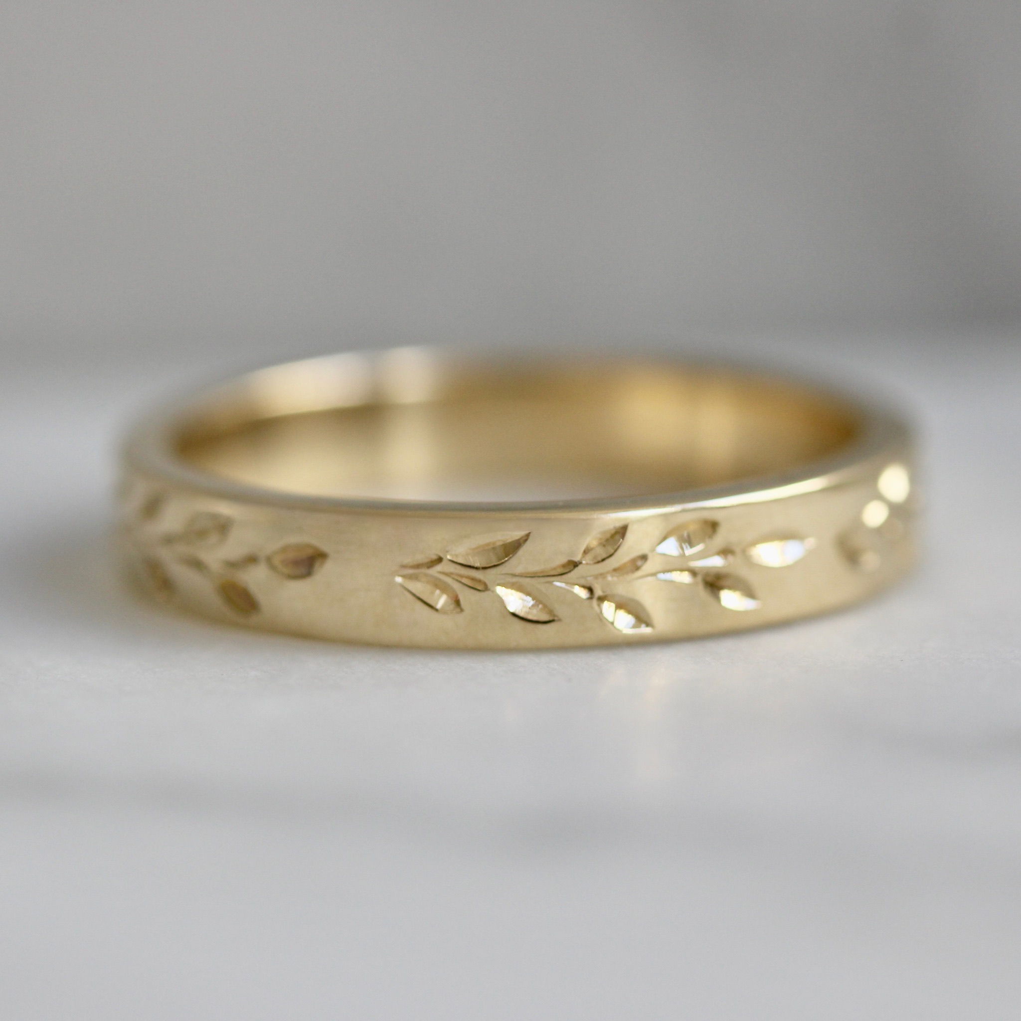 Hand-engraved wedding band with vines and leaves