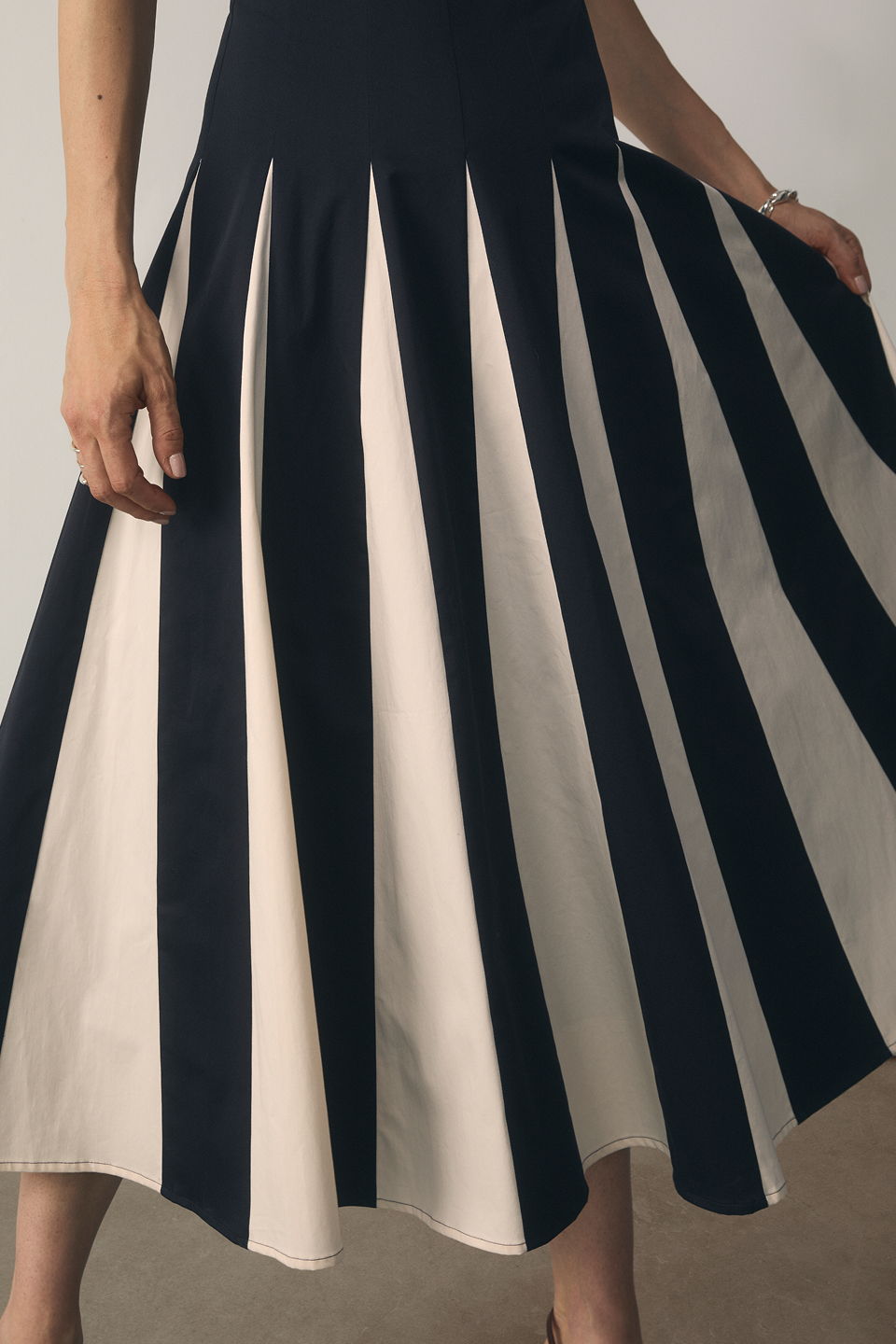 Model wearing navy and stone Salina dress