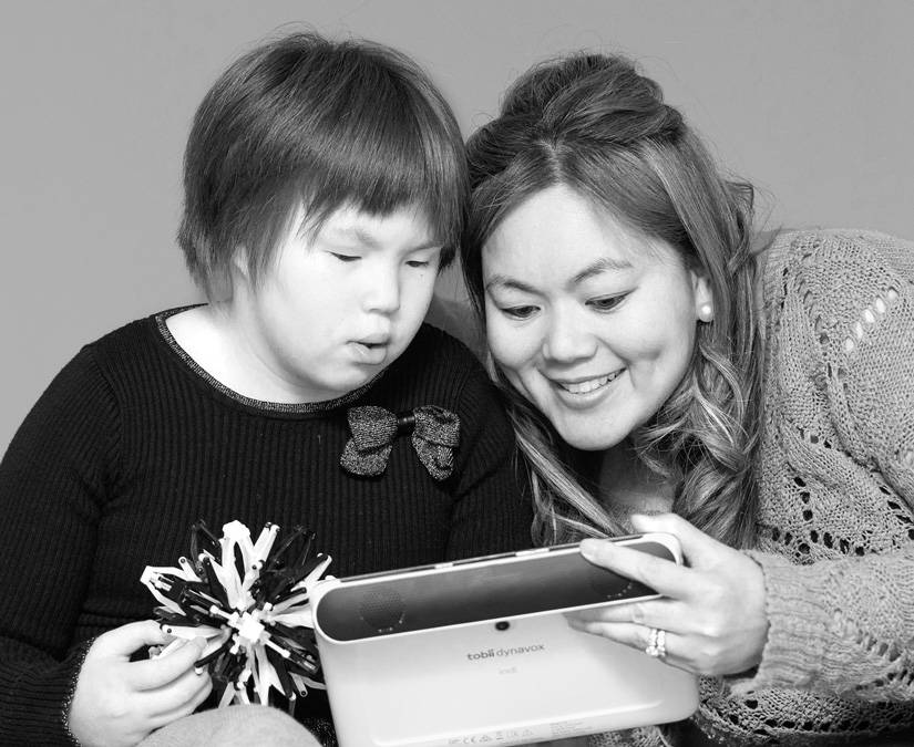 Child and mom using their Tobii Dynavox Indi device