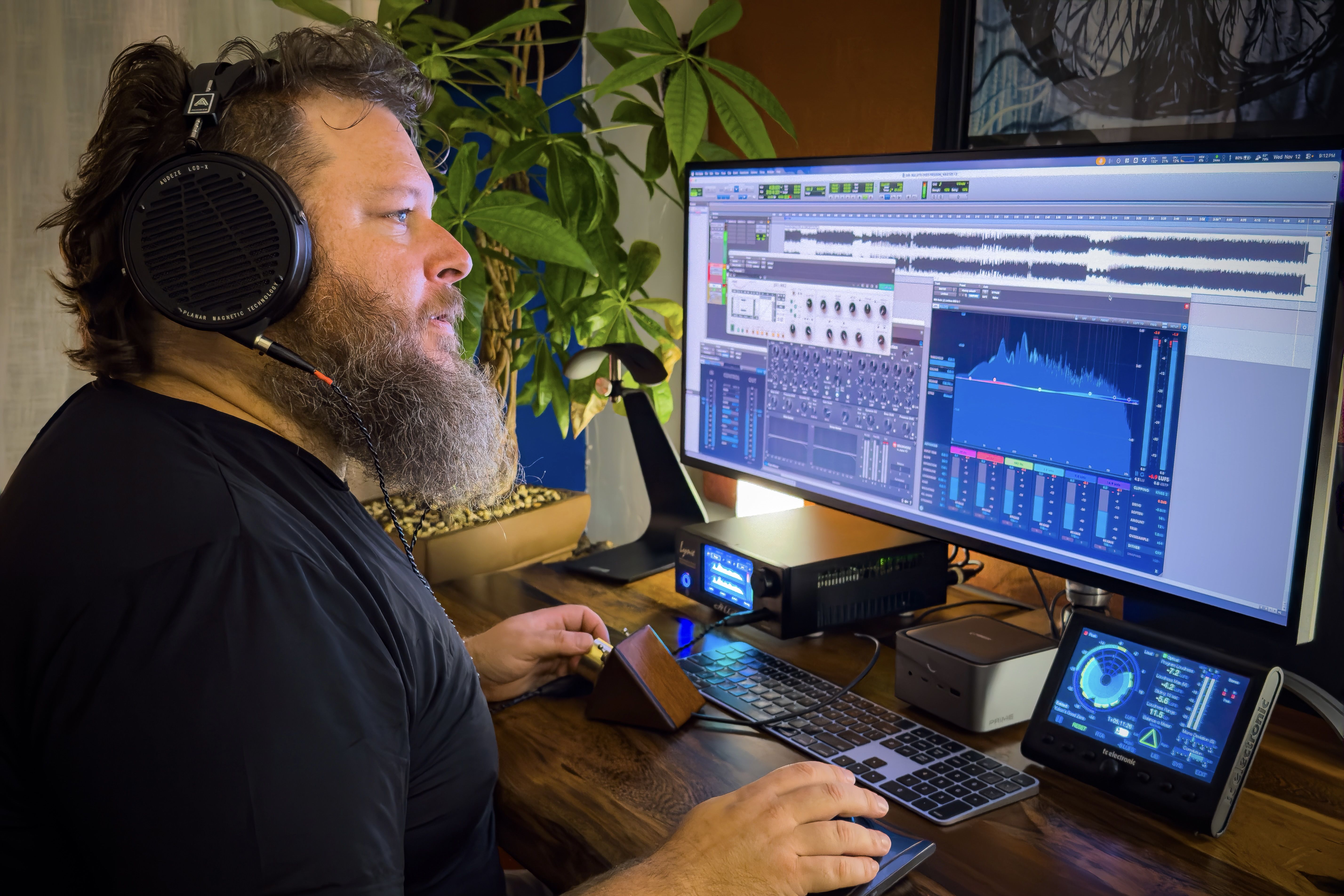 Yukon wearing Audeze LCD-X headphones mixing on the computer