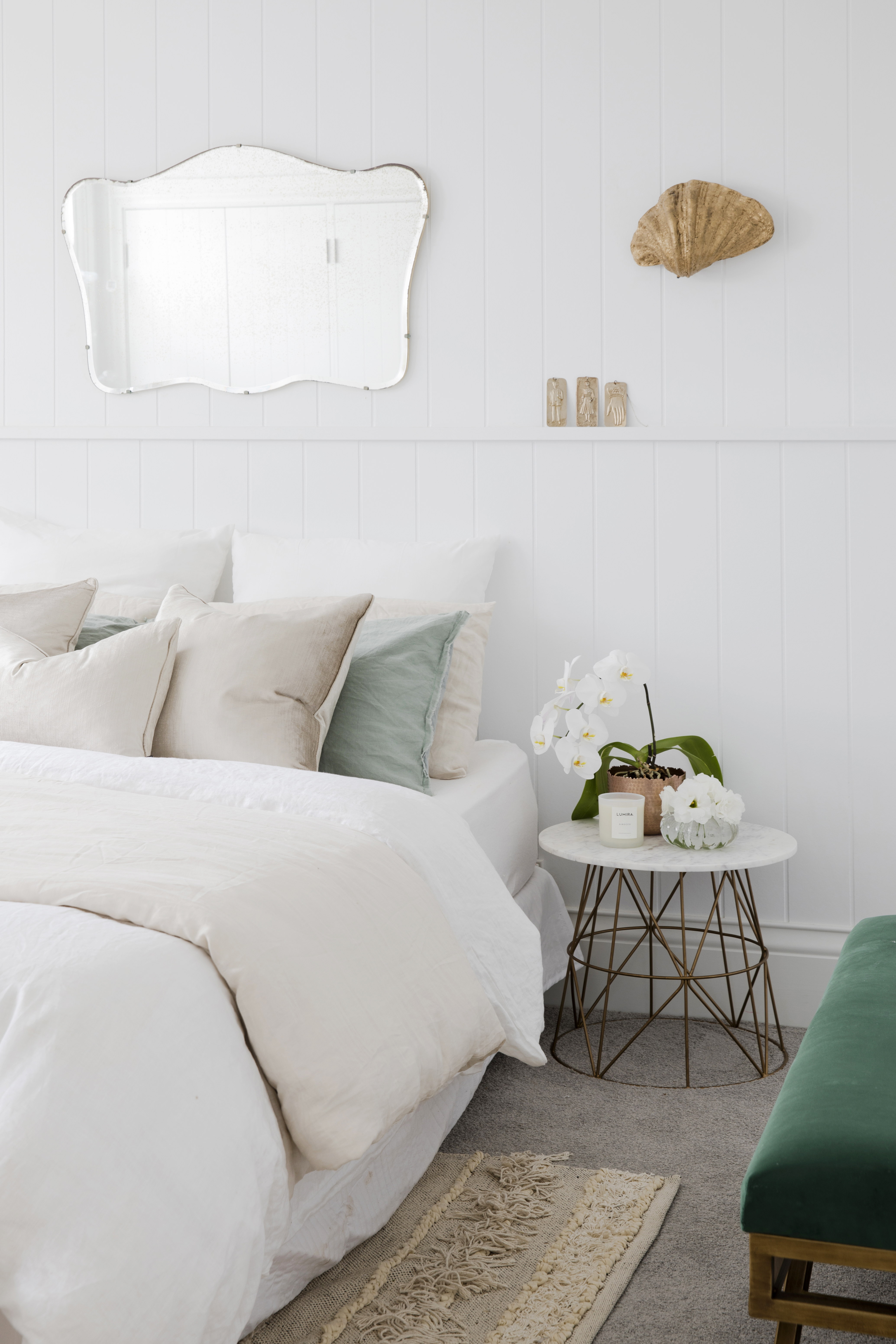 Gold Shell Wall Light above a bedside table