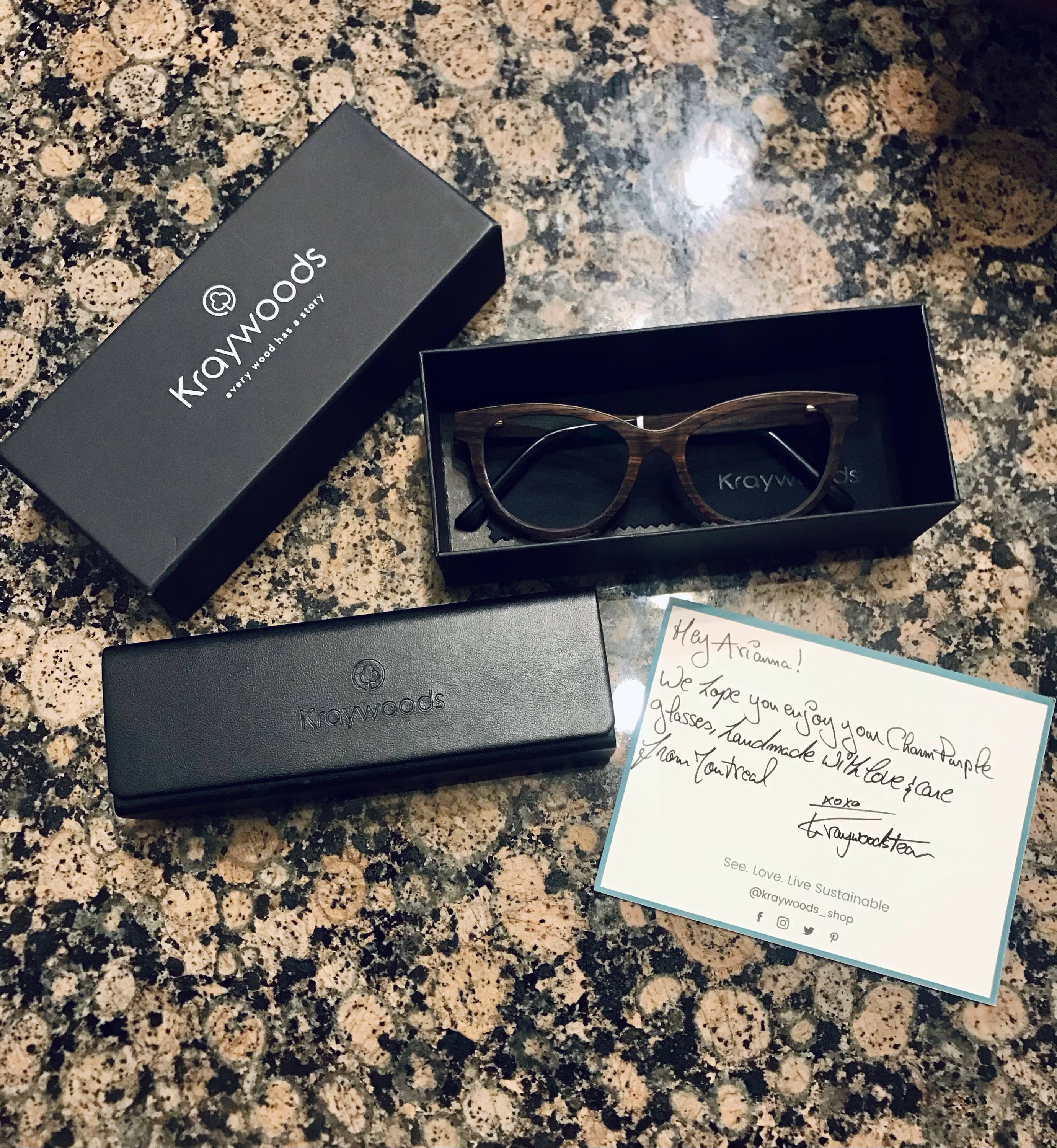 An unboxing of packaging of Charm Purple, Cat-Eye Eyeglasses made from Sandal Wood on a marble kitchen counter