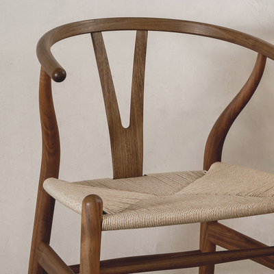 A wooden chair with a curved backrest and woven seat.