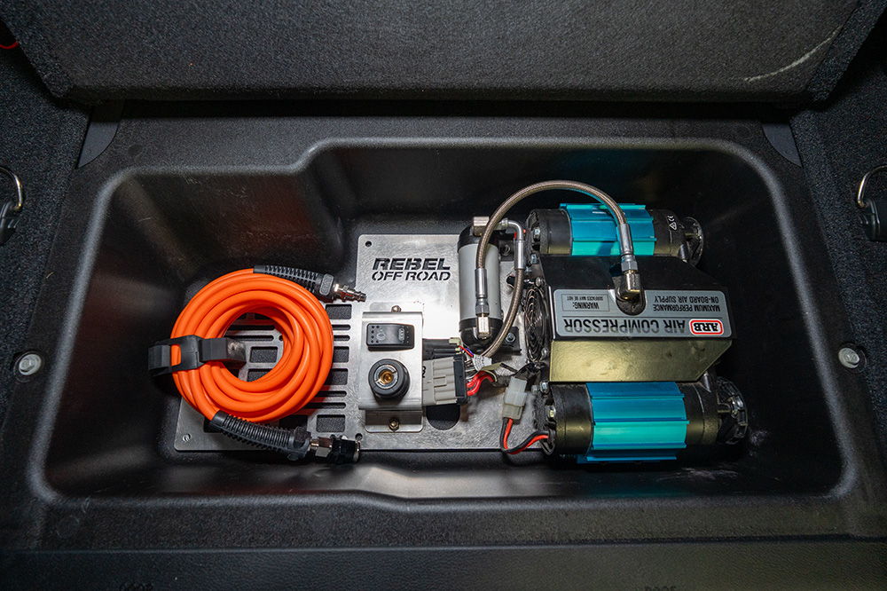 Electrical components and equipment inside a storage compartment.