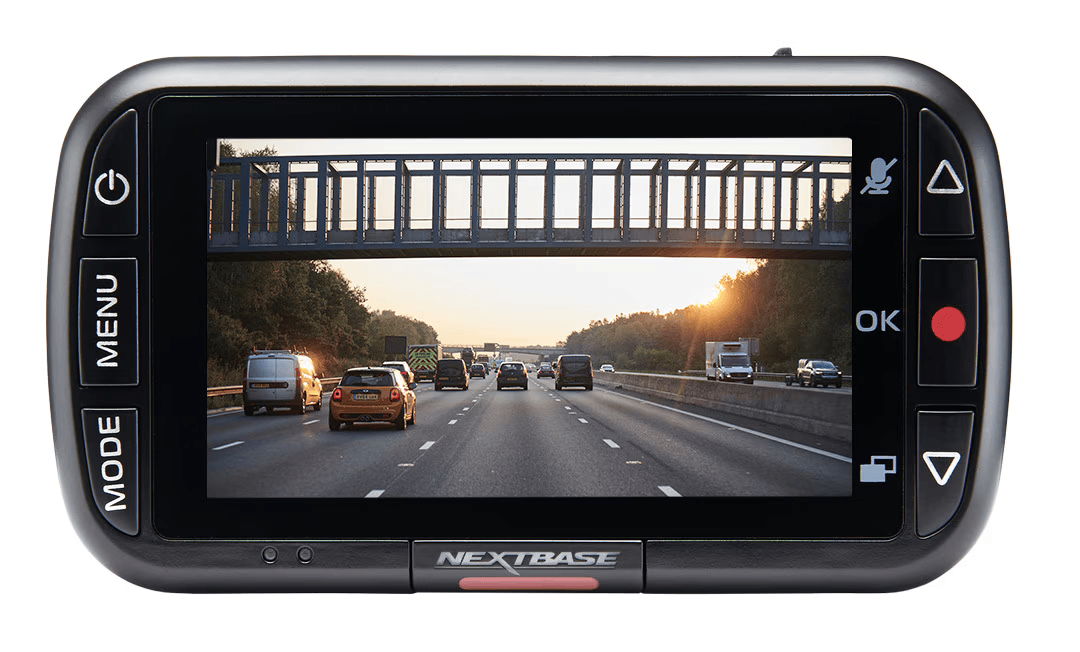 A device displaying a highway scene with a bridge overhead during sunset.