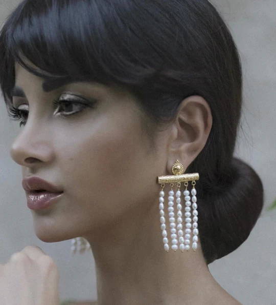 Eleanora Maressa wears Soru Jewellery  gold and pearl strand earrings 