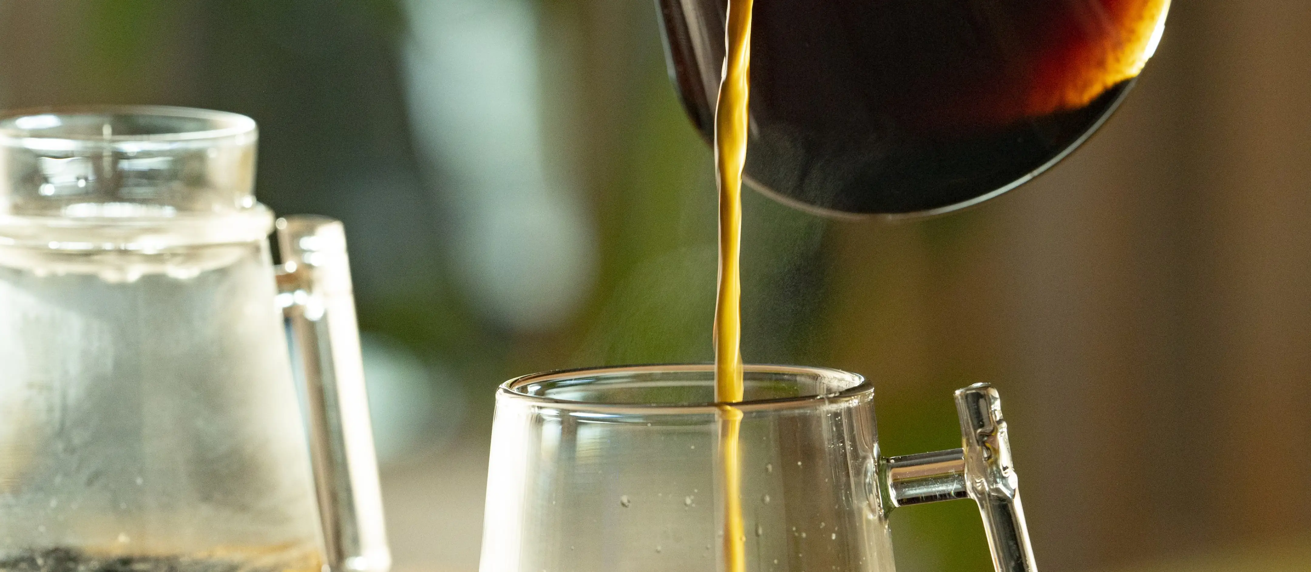 Coffee pouring from the Pure Over brewer into a glass cup on a slow morning