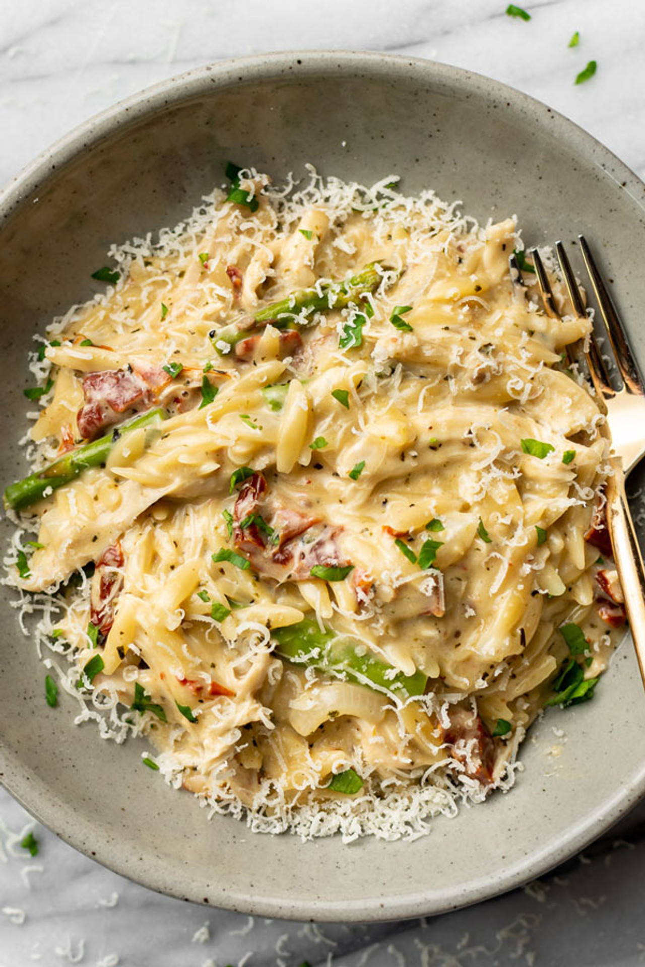 Creamy pesto chicken and orzo with sun dried tomatoes and asparagus
