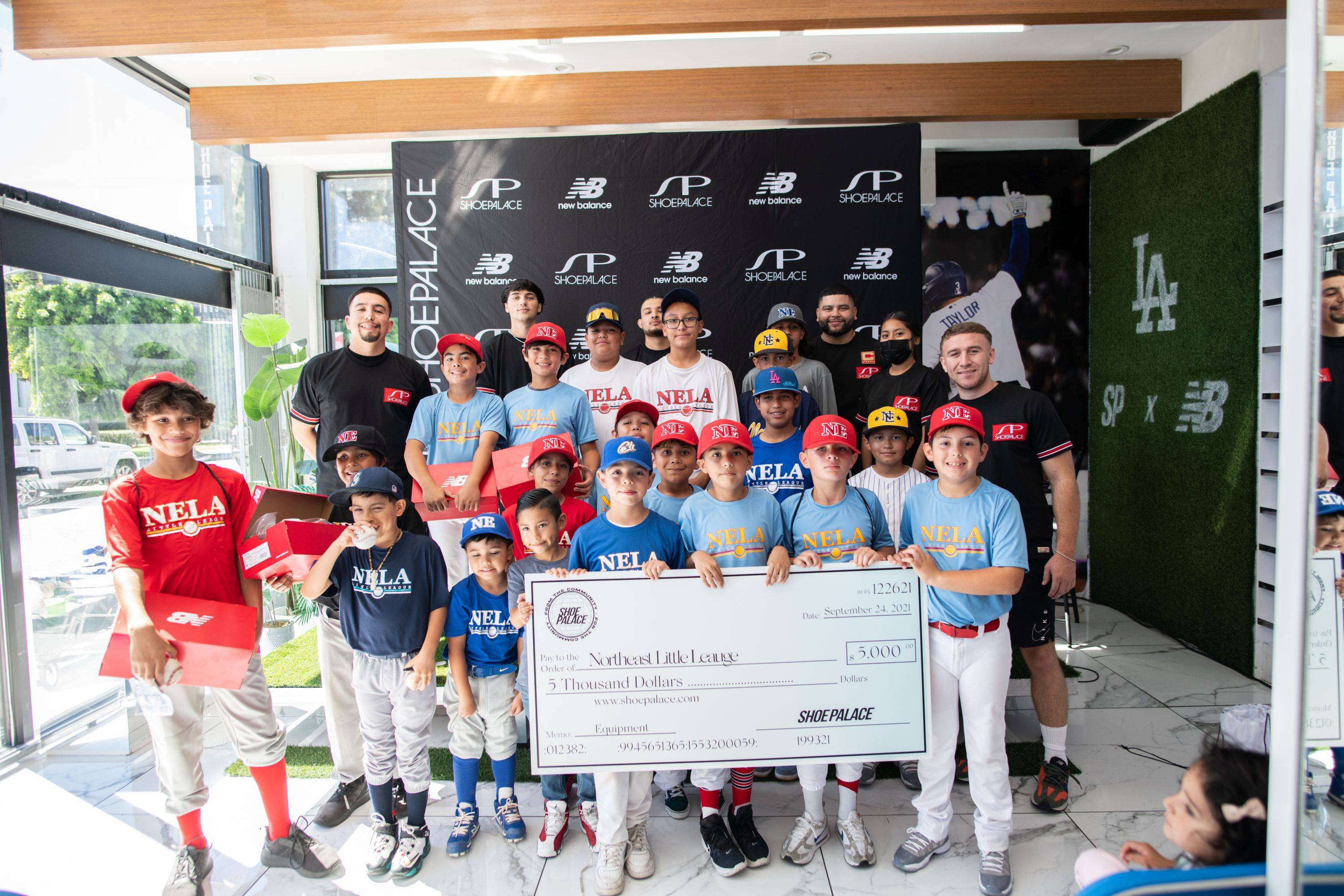 new balance little league event with the check