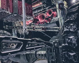 Close-up of burgundy train horns mounted under lifted truck