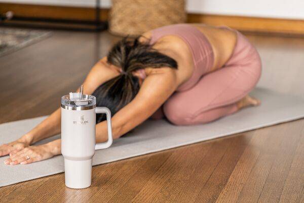 Woman Doing Yoga With A Stanley Quencher Water Tumbler