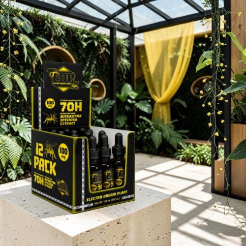 Box of 12 bottles in a greenhouse with plants and yellow curtains.