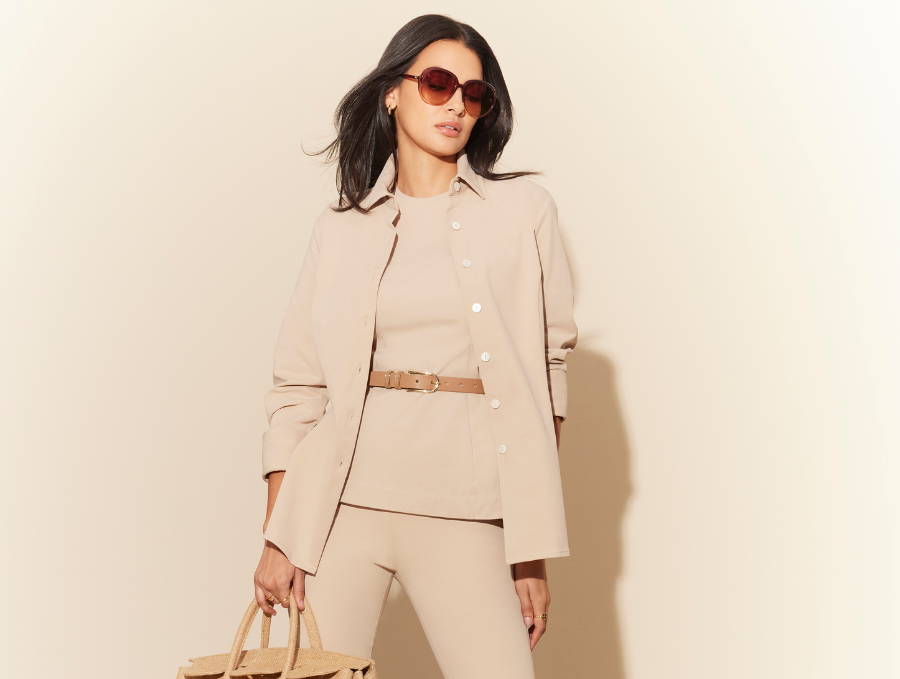 Woman wearing khaki jacket with khaki top and matching khaki pants with brown leather belt and brown sunglasses by Ala von Auersperg