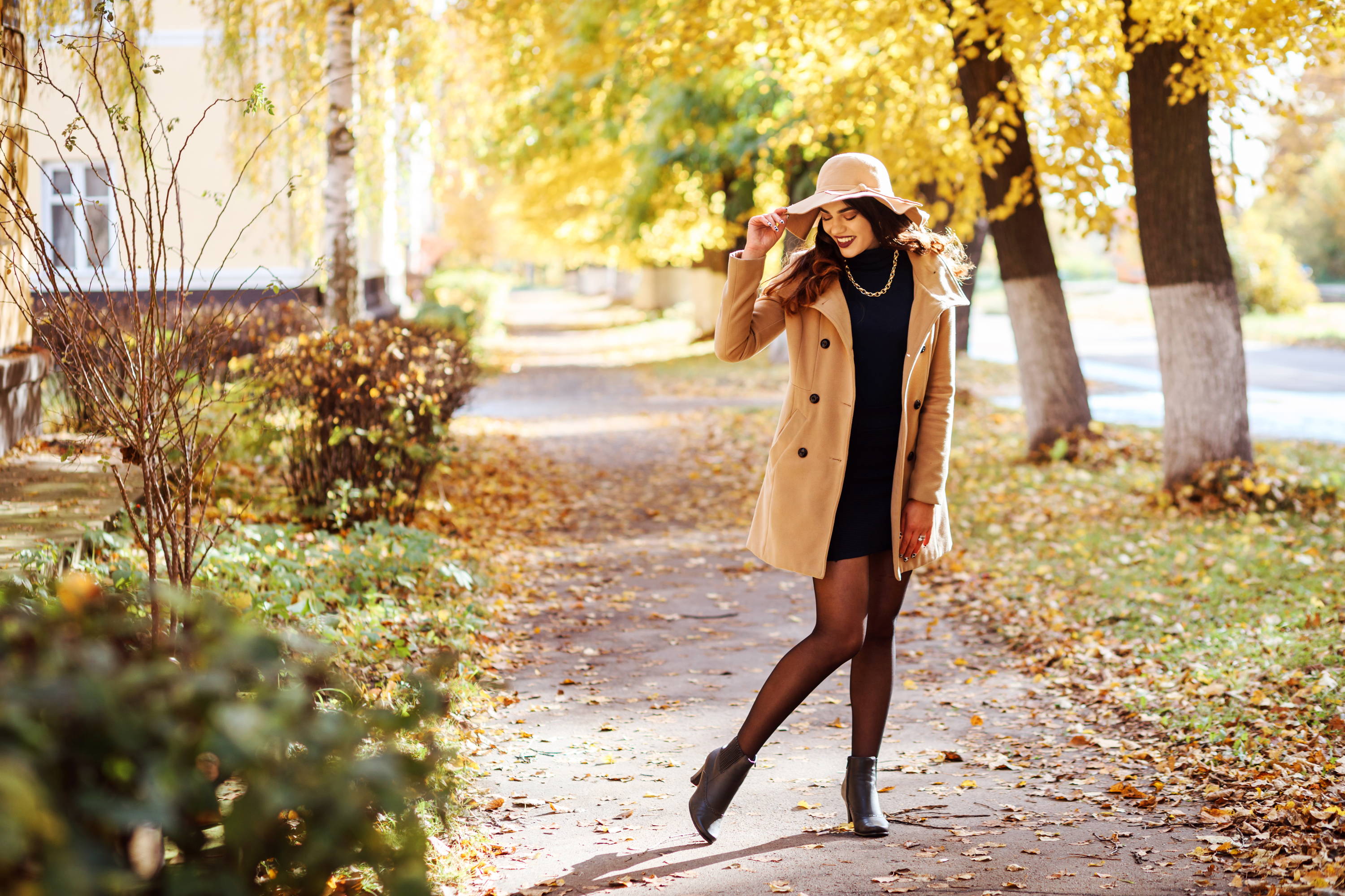 Stylish woman walking on sidewalk, woman wearing compression