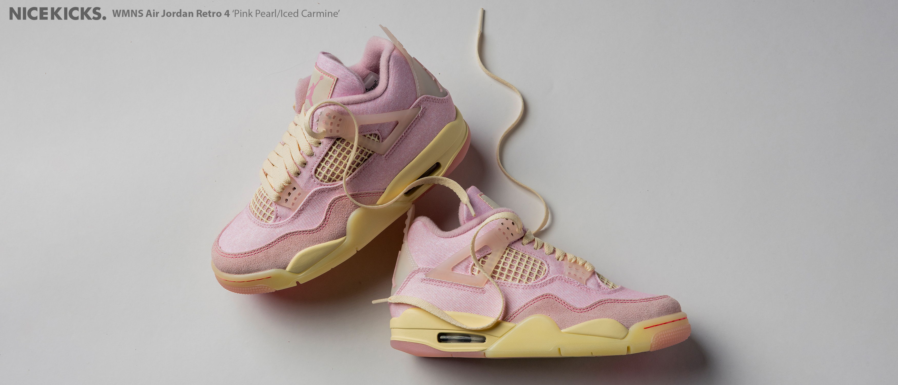 Pink and yellow sneakers with laces loosely tied.