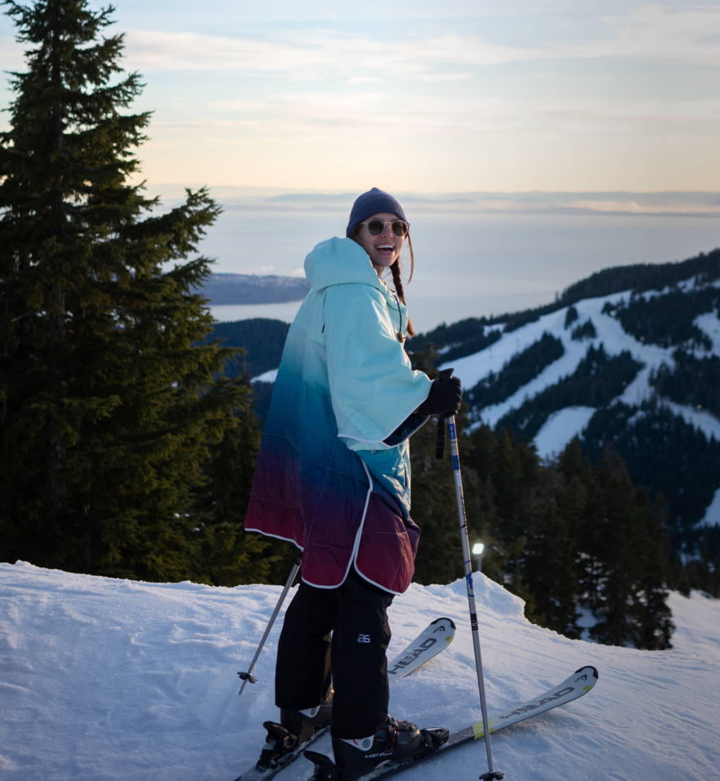 Person on skiis wearing a Rumpl Puffy Poncho