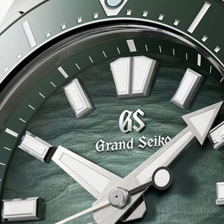 Close-up of a Grand Seiko watch face with green dial.