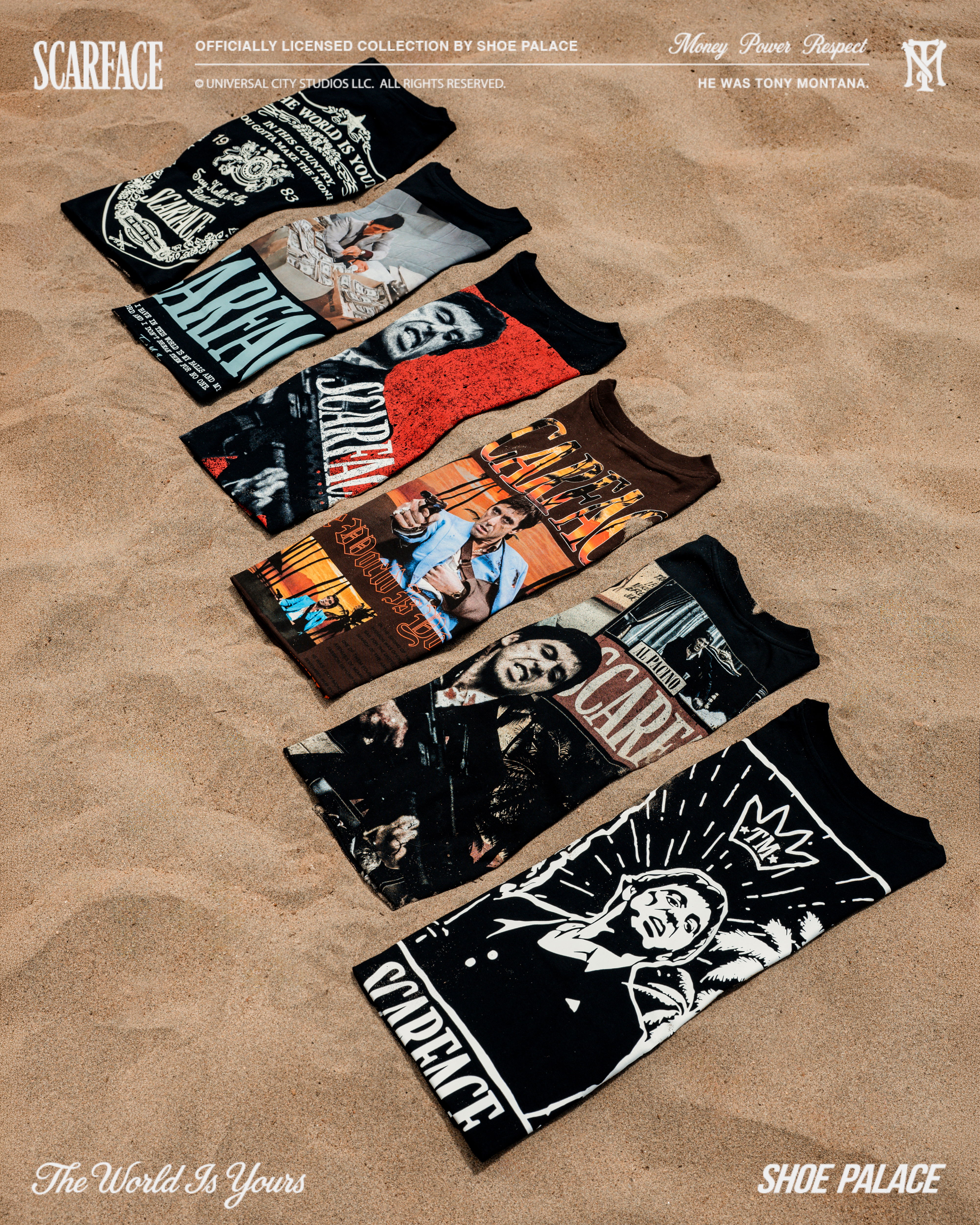 Five Scarface-themed t-shirts laid out on sandy surface.