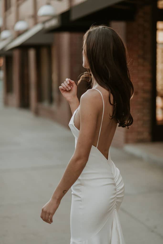 Bride wearing the Grace Loves Lace Clo gown with low back and ruching on the seam