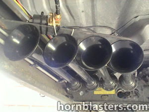 Four black train horn bells mounted under truck