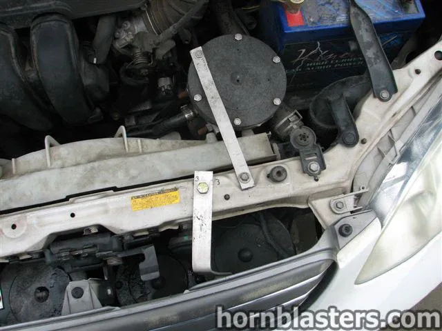 Circular horn device radiator support strap Kinetik battery engine bay 2001 Toyota Corolla Nathan AirChime K5LA gallery photo 15