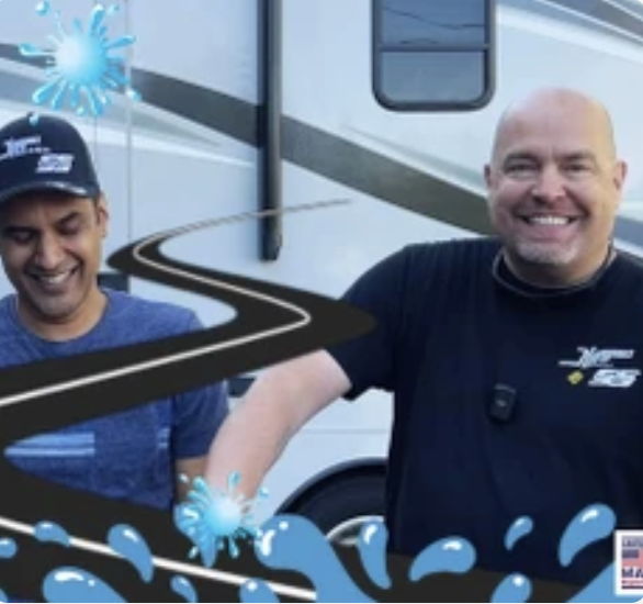 Two smiling men in front of an RV with water graphics.