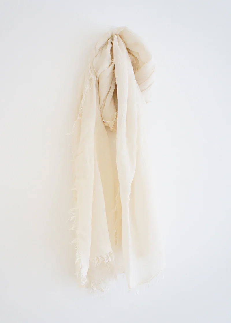 A pale, off white bamboo scarf with raw hem detail